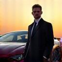 Portrait of a man standing next to a modified car